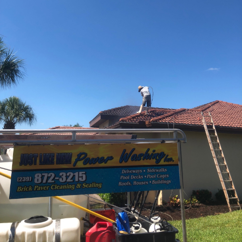 Our pressure washers up on the roof of a home, giving it a thorough, professional cleaning